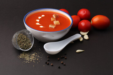 Tomato soup with croutons and fresh cream and tomatoes 