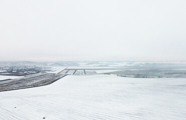 Fototapeta na wymiar Top view of winter snow agro field