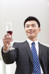 Portrait of businessman holding a glass of wine