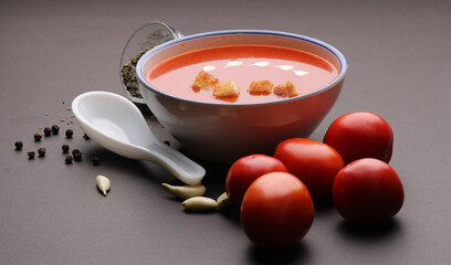Tomato soup with croutons and fresh cream and tomatoes 
