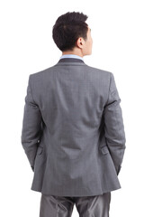 Portrait of young businessman standing in white background,back view
