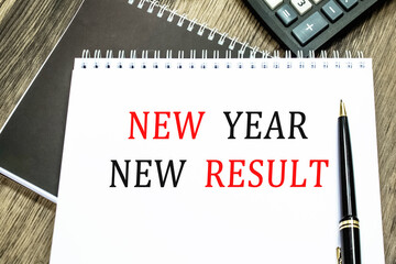 NEW YEAR NEW RESULT. THE TEXT IS WRITTEN IN A NOTEBOOK.