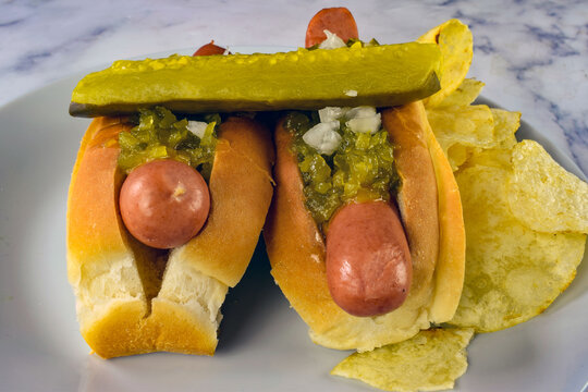 two hot dfogs and a pickle