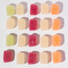 Fruit colorful marmalade sweets, jelly candies on white wooden background