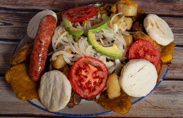 fritanga or picada, traditional Colombian food. This dish is mainly composed of: beef, chicken,...