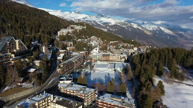 Aerial footage of the famous Crans-Montana ski resort in Canton Valais in the alps in Switzerland, shot on a sunny winter day