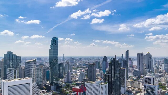 Bangkok business district city center above Silom area, with cloud pass over buildings and skyscrapers, panning right – Time Lapse
