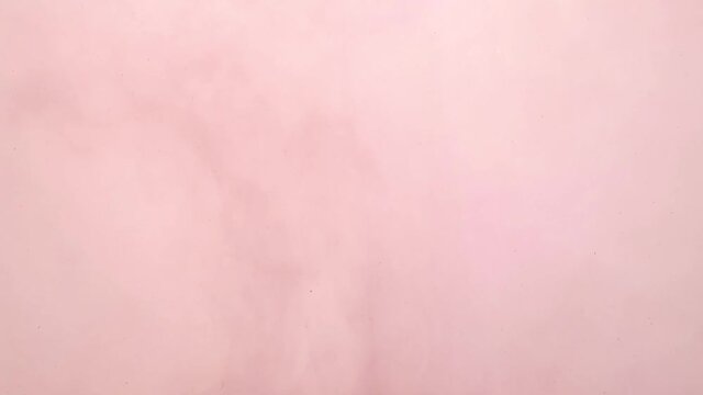Violet and brown ink spreading in water on white. Abstract color background, liquid smoke, psychedelic and art concept.