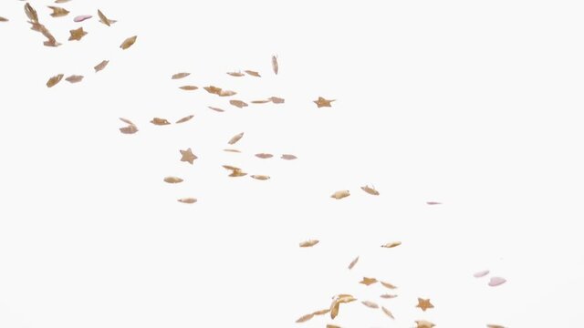 Sugar stars fall in water in an aquarium on white background, objects into liquid. healthy food concept