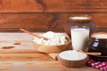 Dairy products on wooden table over blue background