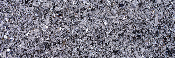 Metal shavings. Panoramic background of metallic chips. Processing of ferrous metals in a factory