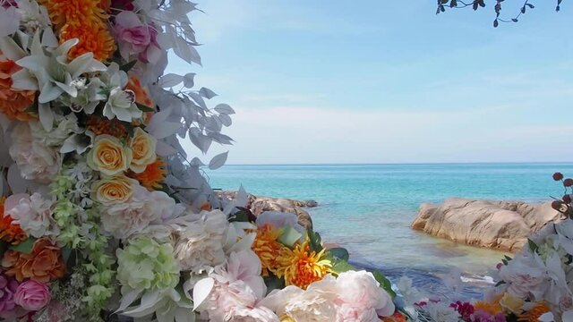 Beautiful flowers decorated at sea beach. Blue sky clearness beach background. Sunlight shine on white roses varieties of tropical flowers. travel in southern Thailand, Kao lak. Nang Tong beck.