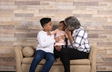 Happy moments with grandma, indian or asian senior lady spending quality time with her grand children 