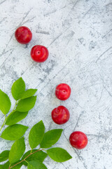 Fresh plums with leaves on the table close-up. Copy space. High quality photo