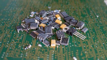 A bunch of used microchips are lying on the circuit board.Reuse of electronic waste.Environmental...