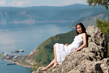 Fototapeta na wymiar A girl of Buryat appearance on Lake Baikal