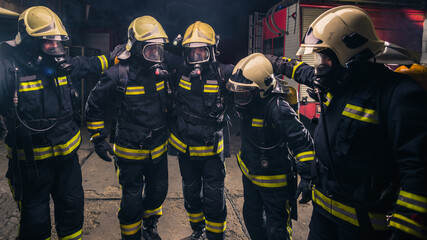 Group of firefighters in the fire department checking their gas mask equipment