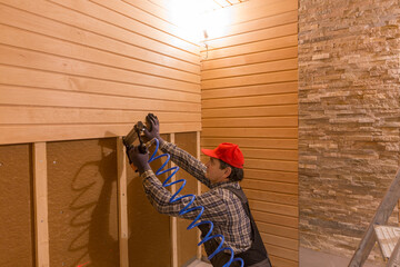 Construction worker thermally insulating eco wooden frame house