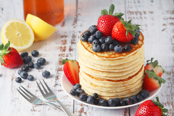 A stack if home-made pancakes with berry
