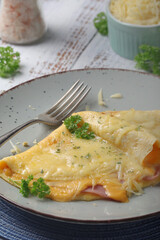 Omelette with ham and cheese on the plate