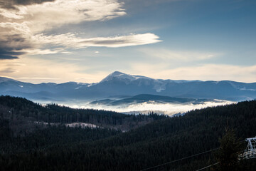 Fototapeta na wymiar forest in the Carpathians in winter and Mount Hoverla