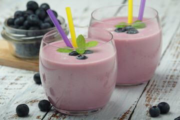 Two glasses with blueberry yogurt	