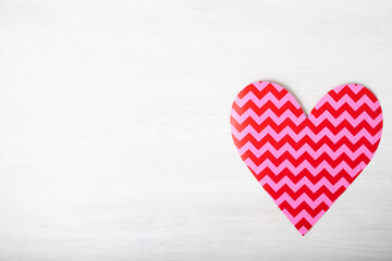 Pink heart with copyspace on white wooden background