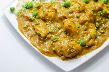 Chicken curry with egg fried rice, chicken breast pieces in a mildly spiced coconut curry sauce with fried rice with peas and egg