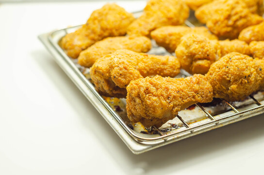 Southern crispy battered fried chicken wings, deep-fried chicken wings on the metal tray