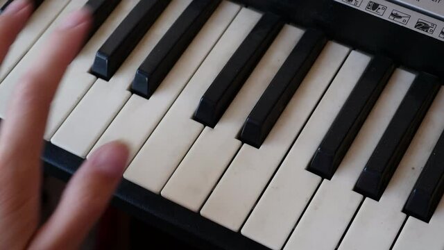 Female Fingers Play Music On The Keys Of An Old, Dirty Synthesizer Dolly Slider Shot.