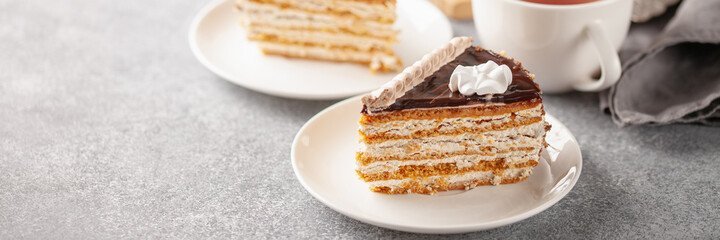 Cake with cream and a decor on a table, a dessert to tea. Selective focus.
