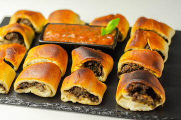 Patty's pies stuffed with minced meat, mushrooms and onion, served with sauce