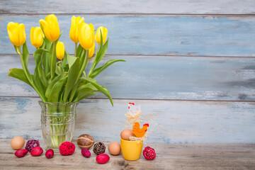 Easter holiday concept with tulip flowers and eggs decorations on wooden table