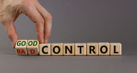 Bad or good control symbol. Businessman turns wooden cubes and changes words 'bad control' to 'good control'. Beautiful grey background. Business and good control concept. Copy space.