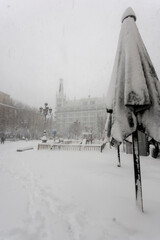 View of the famous Santa Ana square, snowing, in the historical center of Madrid, covered by snow.