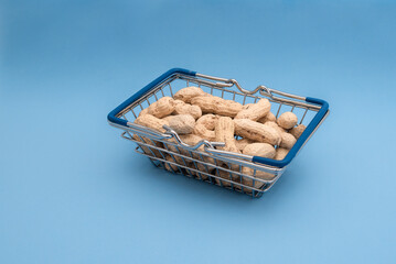 Grocery basket with peanuts on a blue background