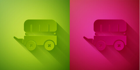 Paper cut Wild west covered wagon icon isolated on green and pink background. Paper art style. Vector.