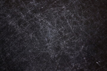 The texture of scratches on fabric on a black background, the texture of a silver reflector in the light