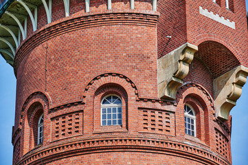 Details of a historic red brick water tower built around 1900 in Berlin, Germany.