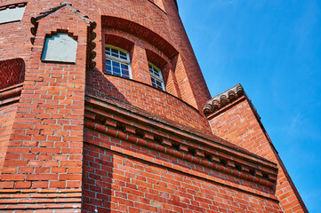 Details of a historic red brick water tower built around 1900 in Berlin, Germany.