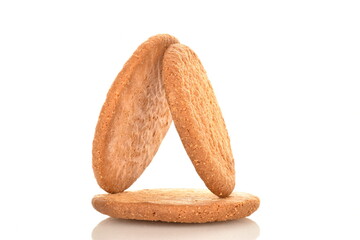 Three freshly baked round American cookies, close-up, isolated on white.