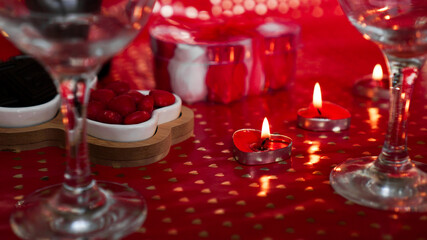 Candles for valentines day, table with festive red background.