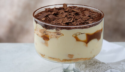 Tiramisu with caramel in a large glass.
