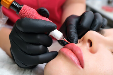 Close up of permanent lip makeup. lip tattoo. - obrazy, fototapety, plakaty
