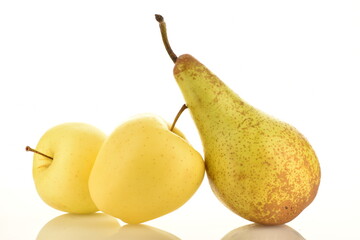 Two ripe yellow apples and one green pear, close-up, isolated on white.