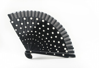 Semi-open black with white circles Spanish flamenco fan. Highlighted on a white background. Side composition.