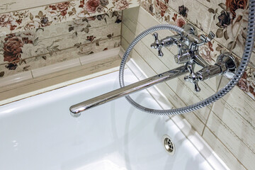 Modern bathroom faucet. Chrome surface traditional interior, austerity and authenticity.