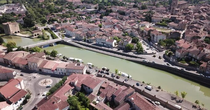 Aerial view of Condom cityscape on banks of Baise river overlooking Catholic cathedral, France