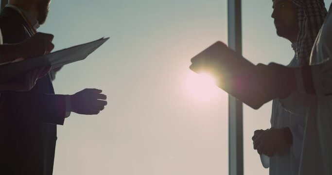 Caucasian and arabian business partners talking interview cooperation agreement consultation contract investment in modern office. Handshake. Successful deal.