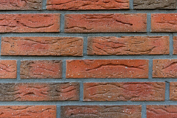 New and clean with rich colors red orange brown brick wall, clinker bricks. Brick texture